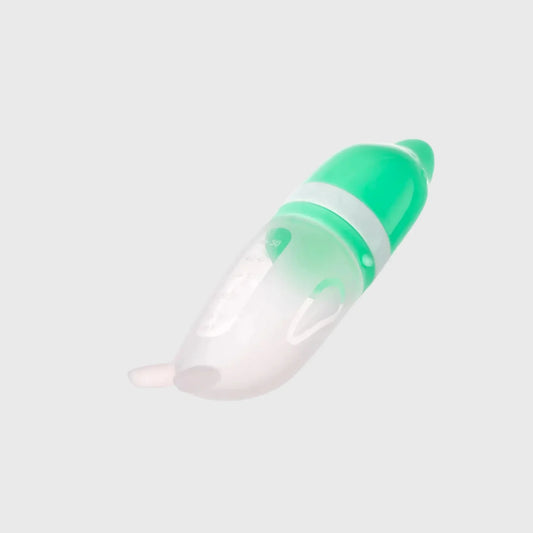 Green and white silicone baby feeder bottle for feeding infants, isolated on grey background