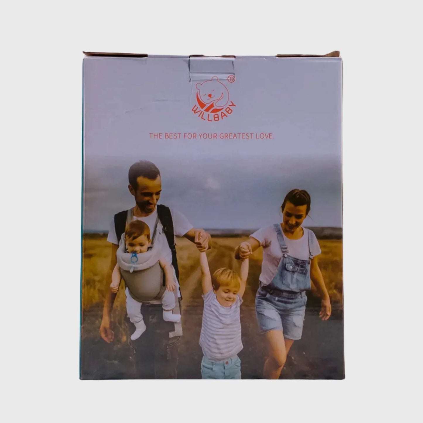 Family outdoors with dad using baby carrier, mom holding child's hand, parenting essentials