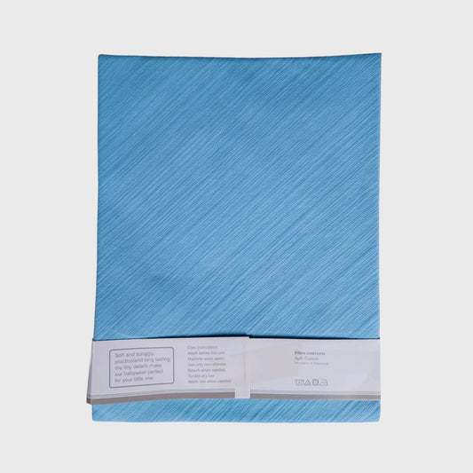 Folded light blue cotton baby bedsheet with care label, soft kids bedding
