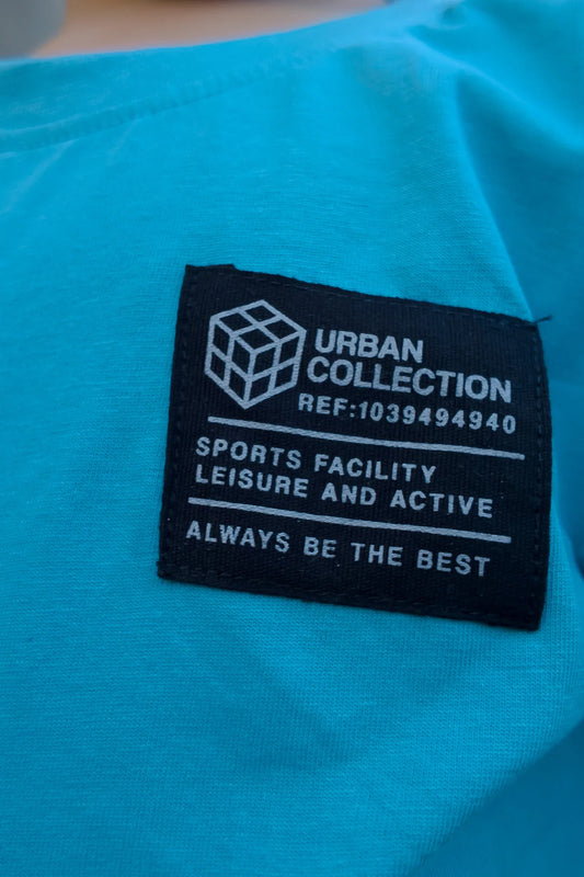 Close-up of black Urban Collection label on blue kids t-shirt, sportswear detail